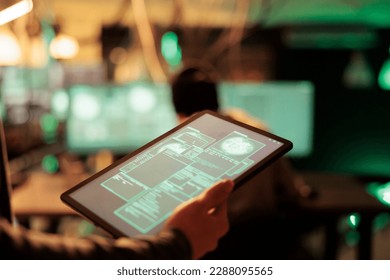 Hacker reading database illegal access message on tablet, successful computer system hacking online. Spies cracking passwords and network server, causing security breach and malware.