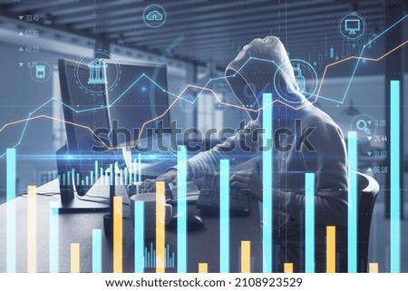 Hacker sitting at desktop using computer with creative glowing business chart on blurry office background. Online banking, safety, hacking and finance concept. Double exposure