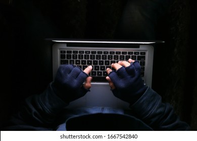 hacker stealing data from laptop, close up 