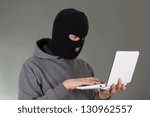 hacker stealing data from white notebook