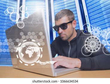 Hacker with sunglasses using a laptop in data center