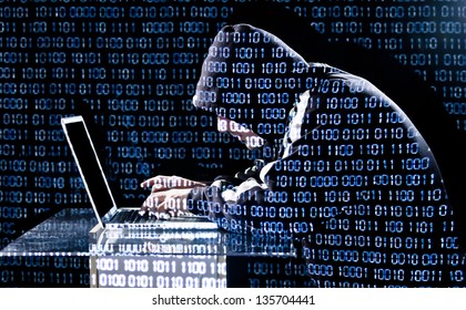 Hacker typing on a laptop with binary code in background