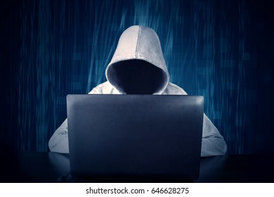 Hacker typing on a laptop with binary code in background