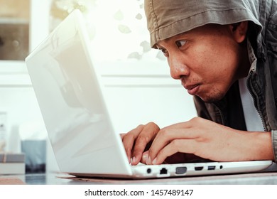 Hacker use laptop for hacking data.
