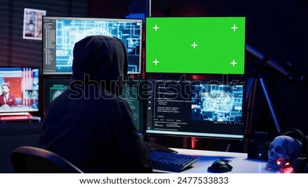 Hacker using AI machine learning and isolated screen computer to produce malware corrupting data. Scammer working on chroma key PC using artificial intelligence tech, infecting systems, camera B