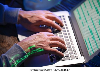 Hacker using computer in dark room