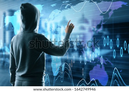 Hacker using glowing stock chart and world map on virtual screen. Hacking and cyber attack concept.
