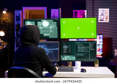 Hacker using green screen PC, coding malware designed to exploit network backdoors. Rogue engineer using mockup computer to bypass security measures such as logins and password protections