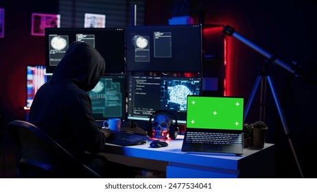 Hacker using isolated screen laptop and AI technology to deploy malware on unsecured devices. Scammer stealing sensitive data from unaware users using mockup notebook, camera B