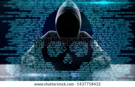 Hacker using laptop with abstract skull shape binary code. Hacking and attack concept. Multiexposure 