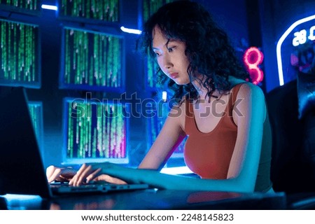 A Hacker is using laptop computer to steal data in the night