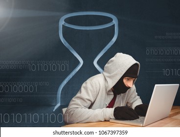 Hacker using a laptop in front of digital background with an hourglass - Powered by Shutterstock - Get 15% off with code: PIKWIZARD15