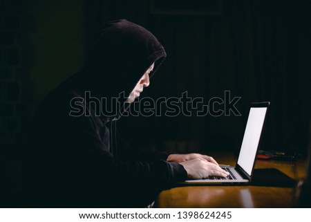 Hacker using laptop. Hacking the Internet
