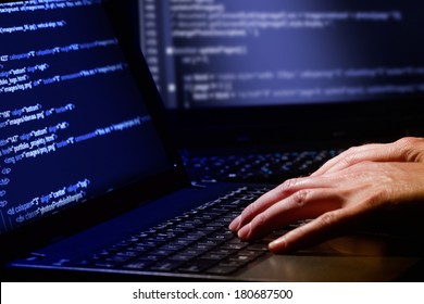 Hacker Using Laptop. Lots Of Digits On The Computer Screen.