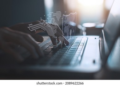 Hacker Using Laptop On The Desk To Hacking System With Binary Code And Upload The Malware With Virtual Screen Display Binary Code, Bar Graph And World Maps On The Background.