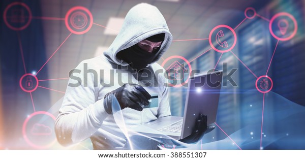Hacker using laptop to steal identity against\
abstract glowing black\
background