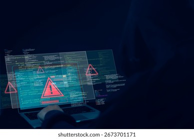 Hacker using laptop with warning alert symbol on screen, representing cyber attack, malware, data breach, computer virus, and online security threat in digital technology.