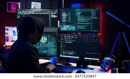 Hacker using PC to steal data, targeting unpatched security systems using malware. Scammer using computer to compromise digital devices, writing rogue script attacking firewalls, camera A