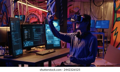 Hacker using virtual reality goggles technology to steal sensitive data by taking advantage of security breaches. Cybercriminal in hidden base using VR headset to gain unauthorized access to systems - Powered by Shutterstock - Get 15% off with code: PIKWIZARD15