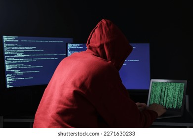 Hacker working with computers in dark room. Cyber attack