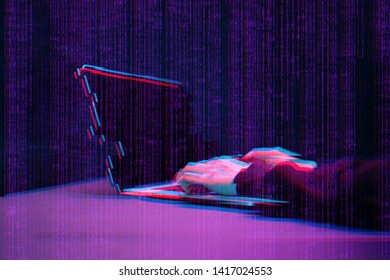 Hacker working with laptop in dark room with digital interface around. Image with glitch effect.