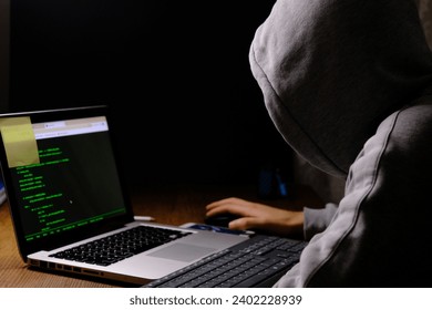 A hacker working on computer in dark 