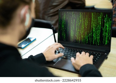 hacker writes code on laptop in matrix style
