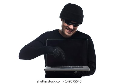 Hacker. Young Men In Black Hat Holding A Laptop And Pointing The Keyboard While Standing Isolated On White