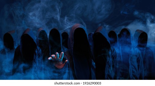 Hackers army. Dangerous hooded group of hackers. Internet, cyber crime, cyber attack, system breaking and malware concept. Dark face. Anonymous. Abstract smoke moves on black background.