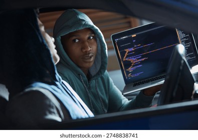 Hackers, men and laptop screen with code in car for ransomware, phishing and stealing data. Criminals, tech display and people with cybercrime in vehicle for fraud, malware or network breach at night