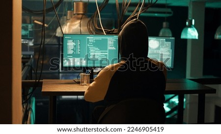 Hackers using network vulnerability to exploit security server, trying to break computer system at night. People working with multiple monitors to hack software, illegal hacktivism.