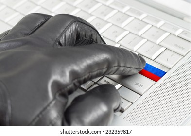 Hacking Russia Concept With Hand Wearing Black Leather Glove Pressing Enter Key With Flag Overlaid