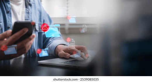 hacking and spam warning symbol on document file. Person using a smartphone and laptop with multiple cybersecurity alerts on a digital interface, highlighting potential data threats. - Powered by Shutterstock