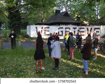 Hackney, London / UK - May 28 2020: People in Hackney mourn local people who have died due to coronavirus in front of a sign which reads "We Grieve", most of the people who died are BAME heritage.