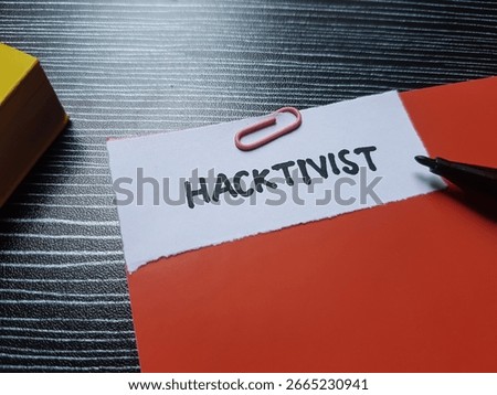 Hacktivist writting on table background.