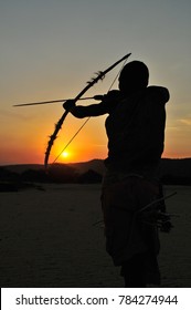 Hadza tribe man hunting during sunset