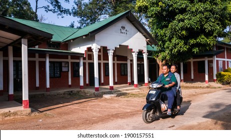 Haflong, Assam, India - January 2018: A Man On A Motorbike Rides Past The Old Vintage Colonial Architecture Of A Building In The Hill Station Of Haflong In The North Cachar Hills Of Northeast India.