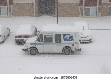 Hagerstown, Maryland - USA - December 16 2020: US Postal Service Vehicle Delivering Mail During A Snow Winter Storm.