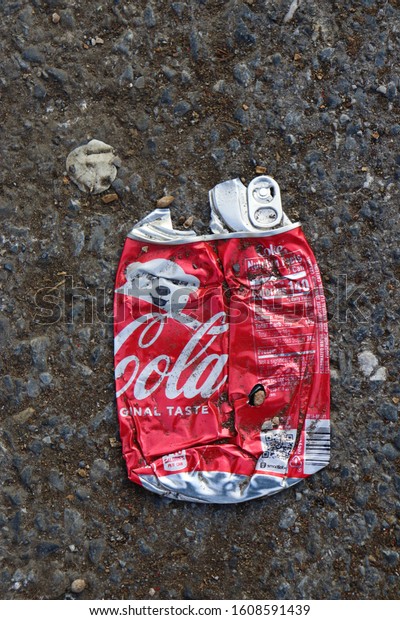 Hagerstown, Maryland / USA - December 7\
2020: Coca Cola can on the floor crushed by\
car.