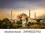 The Hagia Sophia, a historic mosque and former cathedral, stands tall against a backdrop of a dramatic sunset in Istanbul. Hagia sophia at sunset in istanbul