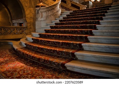 The Hague, Netherlands - April 21 2022 : Elegant Stairs Inside The Famous Peace Palace Of Royal Class With Red Carpet