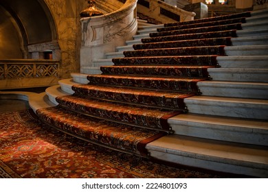 The Hague, Netherlands - April 21 2022 : Elegant Stairs Inside The Famous Peace Palace Of Royal Class With Red Carpet