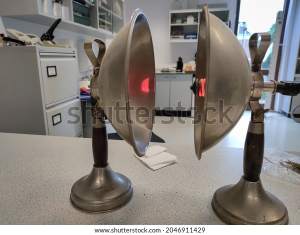 The Hague, Netherlands - August 2021: Two opposing\
parabolic mirrors. Heat radiation from the source will concentrate\
in the focal point in the other mirror. Science experiment, used in\
physics class.