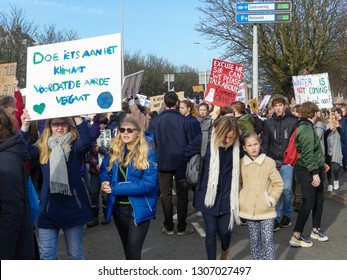 The Hague, the Netherlands - February 7 2019: students at anti climate change protest in The Hague with banners walking through the city