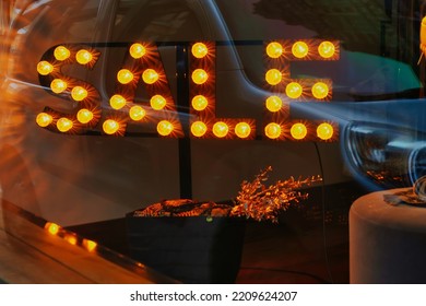 The Hague, Netherlands - January 03 2022: A Vintage Sale Sign In A Window Front Of A Store Made Of Light Bulbs