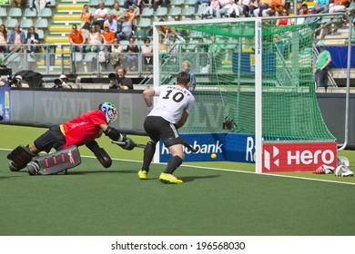 THE HAGUE, NETHERLANDS - JUNE 1: German Field Hockey Player Wesley Races In For The Rebound On Straikowski's Second Goal Against South Africa. Goalie Robinson (RSA) Is Too Late