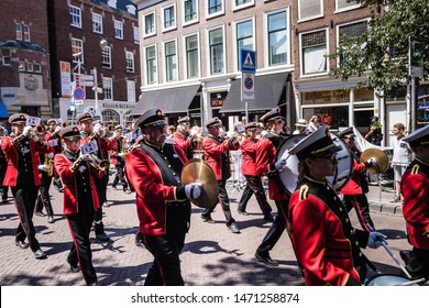 The Hague, The Netherlands - June 30, 2018. The Haaglanden Drum Fanfare Orchestra in red uniform performing and marching in parade on the 2018 Veterans' Day.