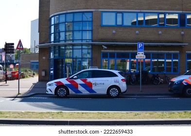 Hague, Netherlands - May 2, 2022: Police Car Near Modern Building In City