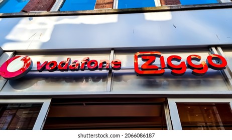 The Hague, The Netherlands - October 8 2021: Combined Name Board Sign Logo Of Dutch Telecommunications Company Ziggo And Vodafone, Both Offering Cable TV, Internet And Telephony Services In 1 Store