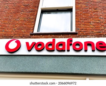 The Hague, The Netherlands - October 8 2021: Dutch Telecommunications Company Vodafone Logo Name Board In Front Store, Merge With Ziggo Offering Cable TV, Internet And Telephony Services In Holland 